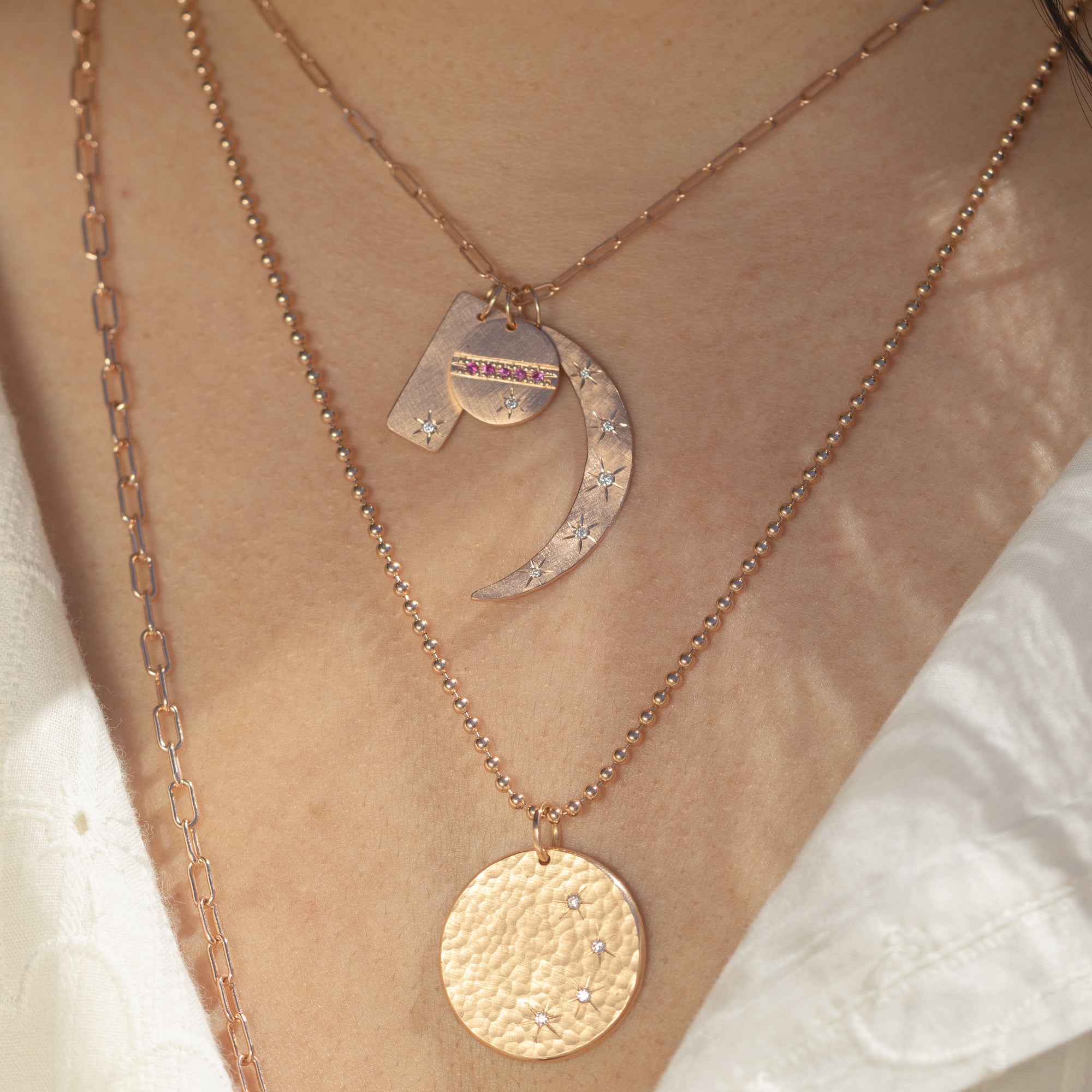 14k rose gold medium MOBI moon pendant with diamonds on model with HALO and GIKS