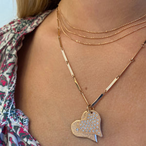 14k gold CHAI on model with hearts