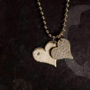 14k gold medium LAVA heart with scattered diamond layered with large LANA heart pendant in lookbook image