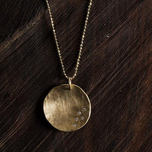 14k gold large MEGG concave medallion with 5 diamonds in studio image