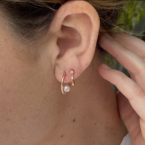 14k gold OADA diamond post earrings on model